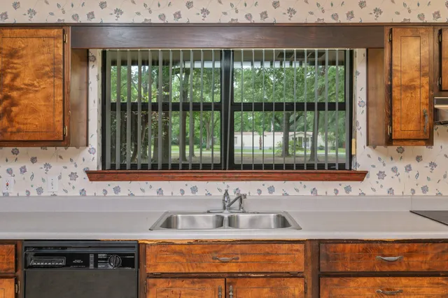 a view of a kitchen with wooden floor and a sink