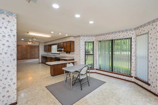 a dining room with furniture and a kitchen view