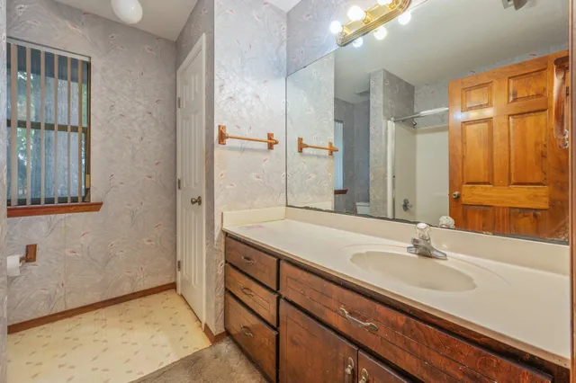 a bathroom with a glass shower door