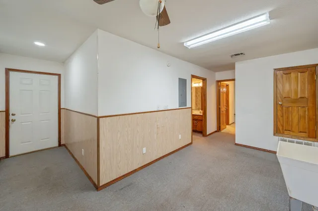 a view of a big room with closet and a ceiling fan