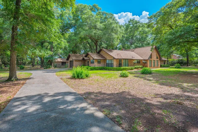 a view of a house with a yard and tree s