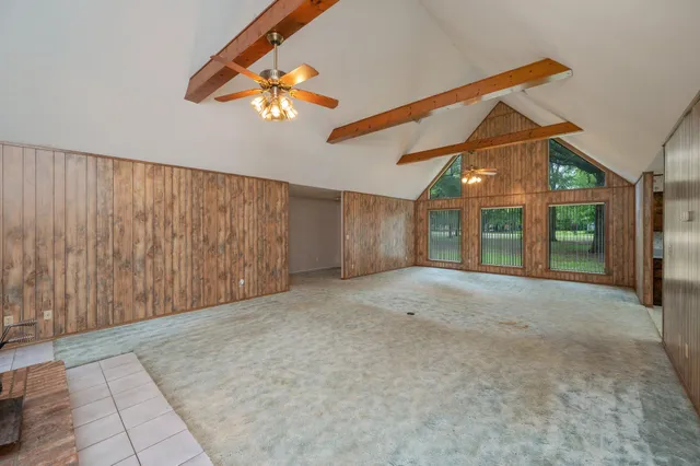 a view of a livingroom with a ceiling fan and window