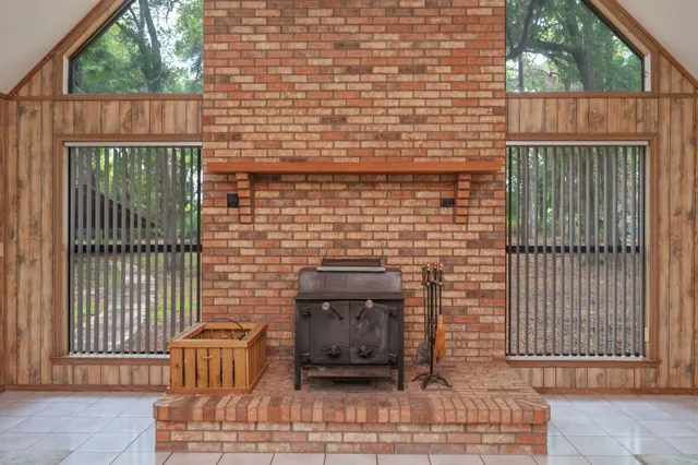 a large kitchen with granite countertop a large counter top appliances and cabinets