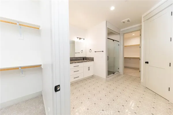 a bathroom with a shower and a sink