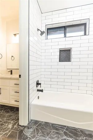 a bathroom with a bathtub and a shower