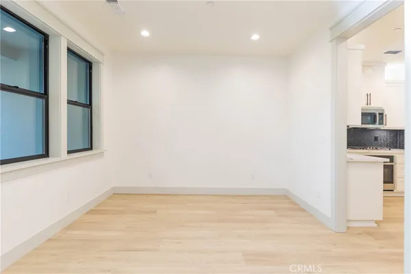 a view of empty room with wooden floor