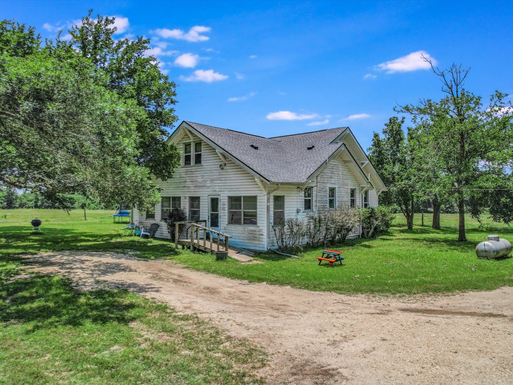 Undisclosed Address Coupland, TX 78615 - Photo 4 of 11 a front view of a house with garden