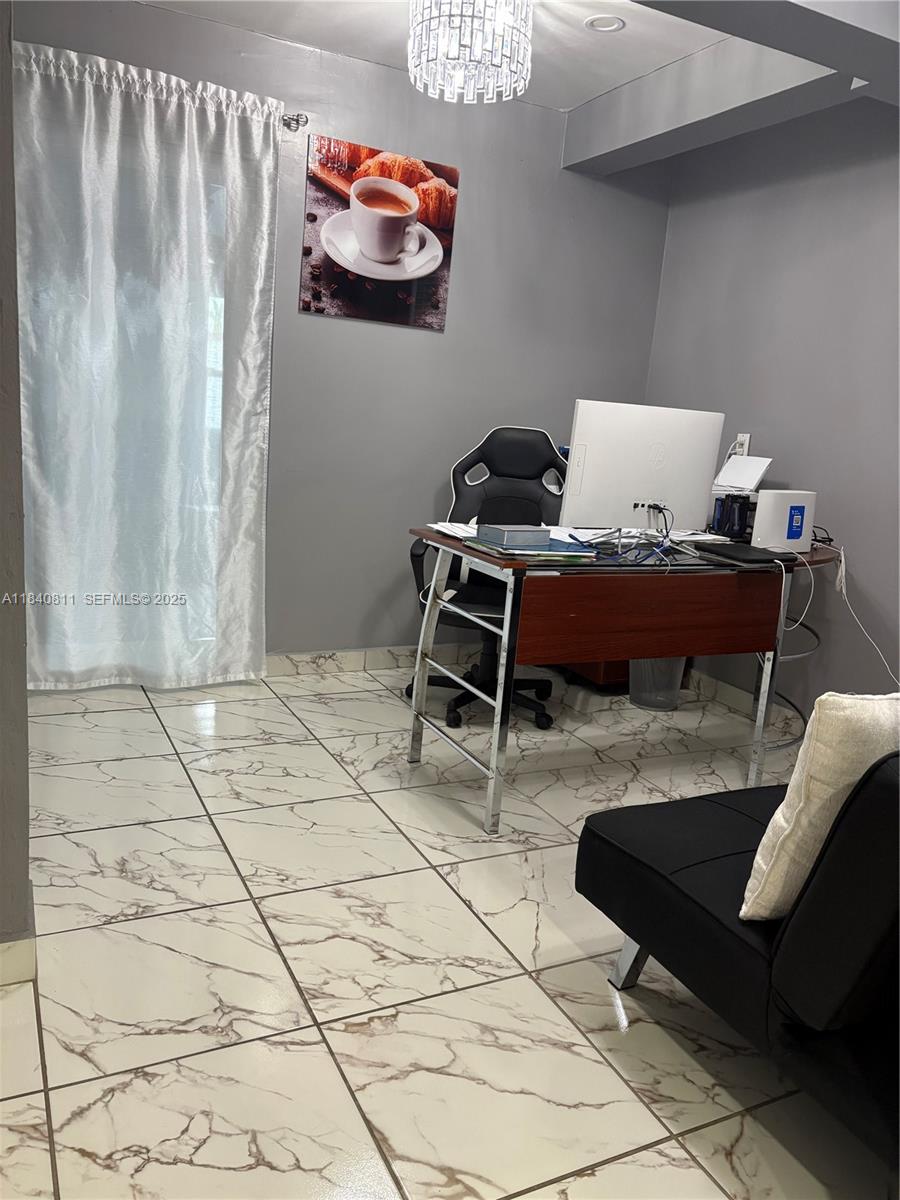 821 East 13th Street Hialeah, FL 33010 - Photo 13 of 25 a living room with a couch and a table