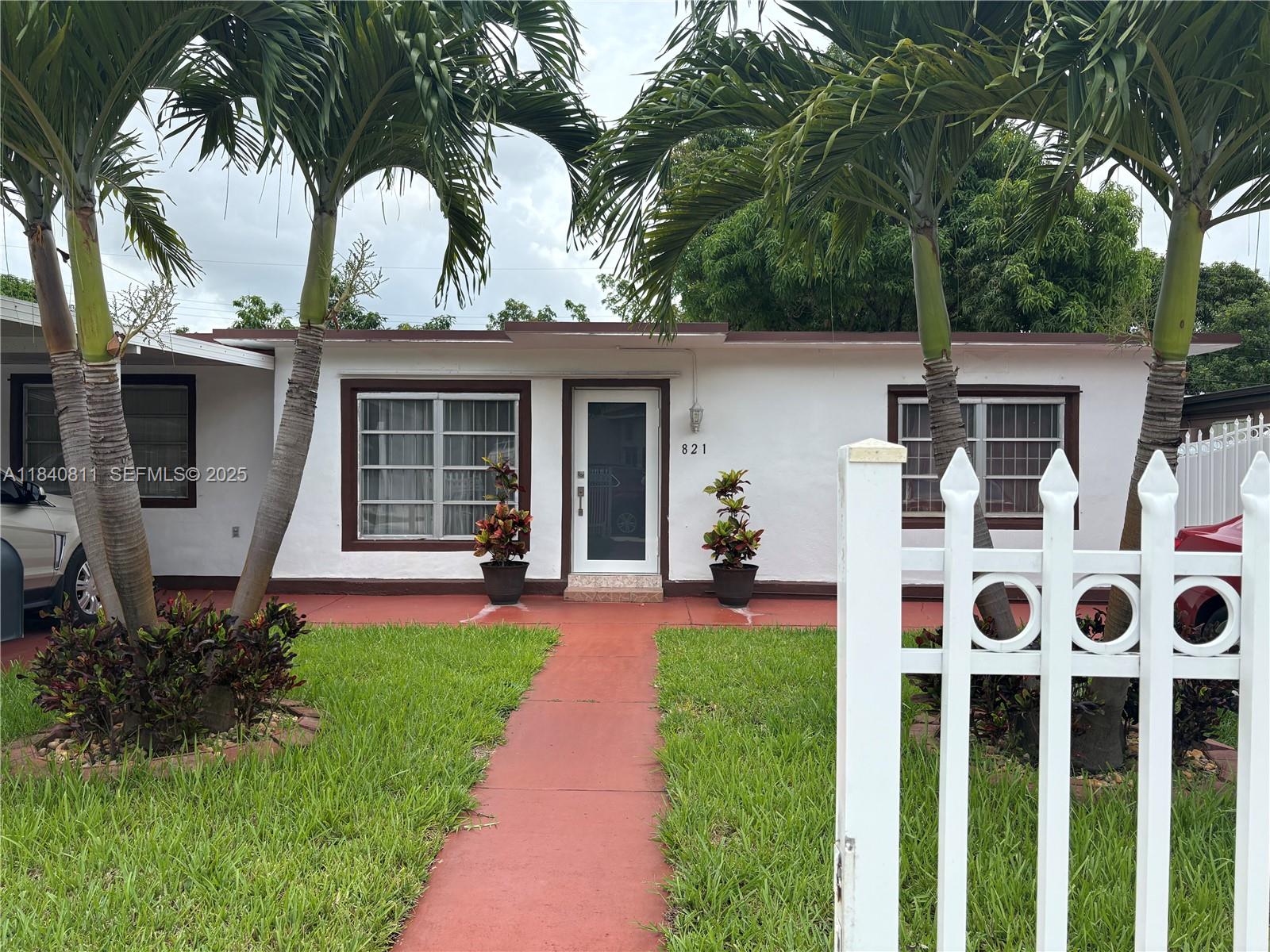 821 East 13th Street Hialeah, FL 33010 - Photo 2 of 25 a front view of house with yard and green space
