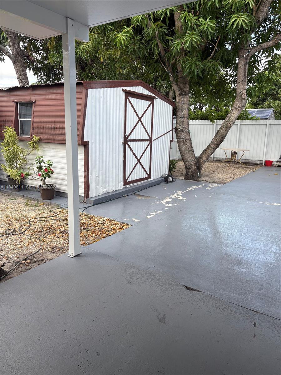 821 East 13th Street Hialeah, FL 33010 - Photo 22 of 25 a view of a house with backyard and a tree