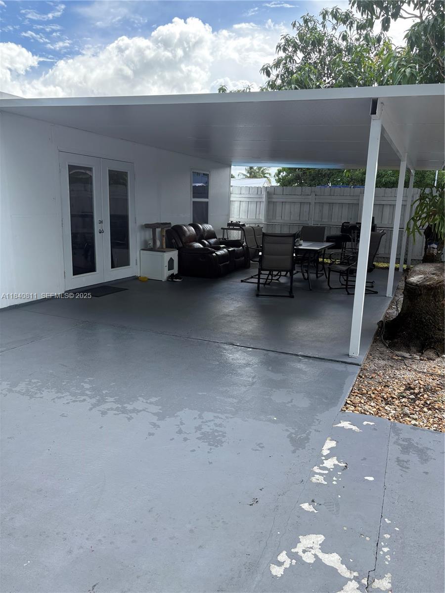 821 East 13th Street Hialeah, FL 33010 - Photo 23 of 25 a view of a patio with table and chairs potted plants with wooden floor