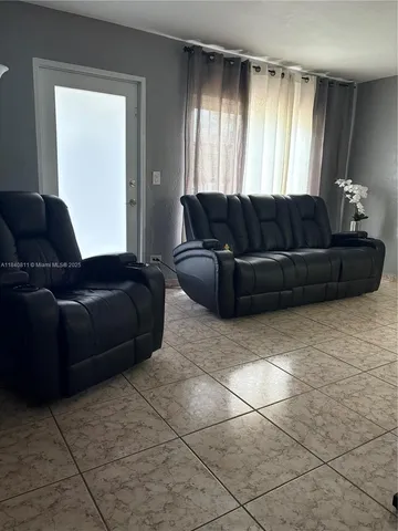 a living room with a couch and a window