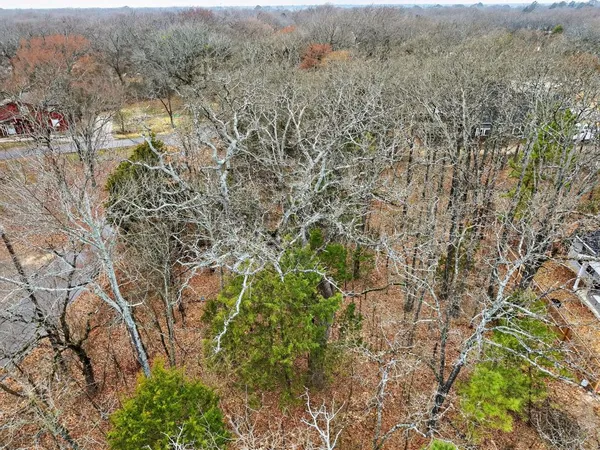 an aerial view of house with yard and mountain view in back