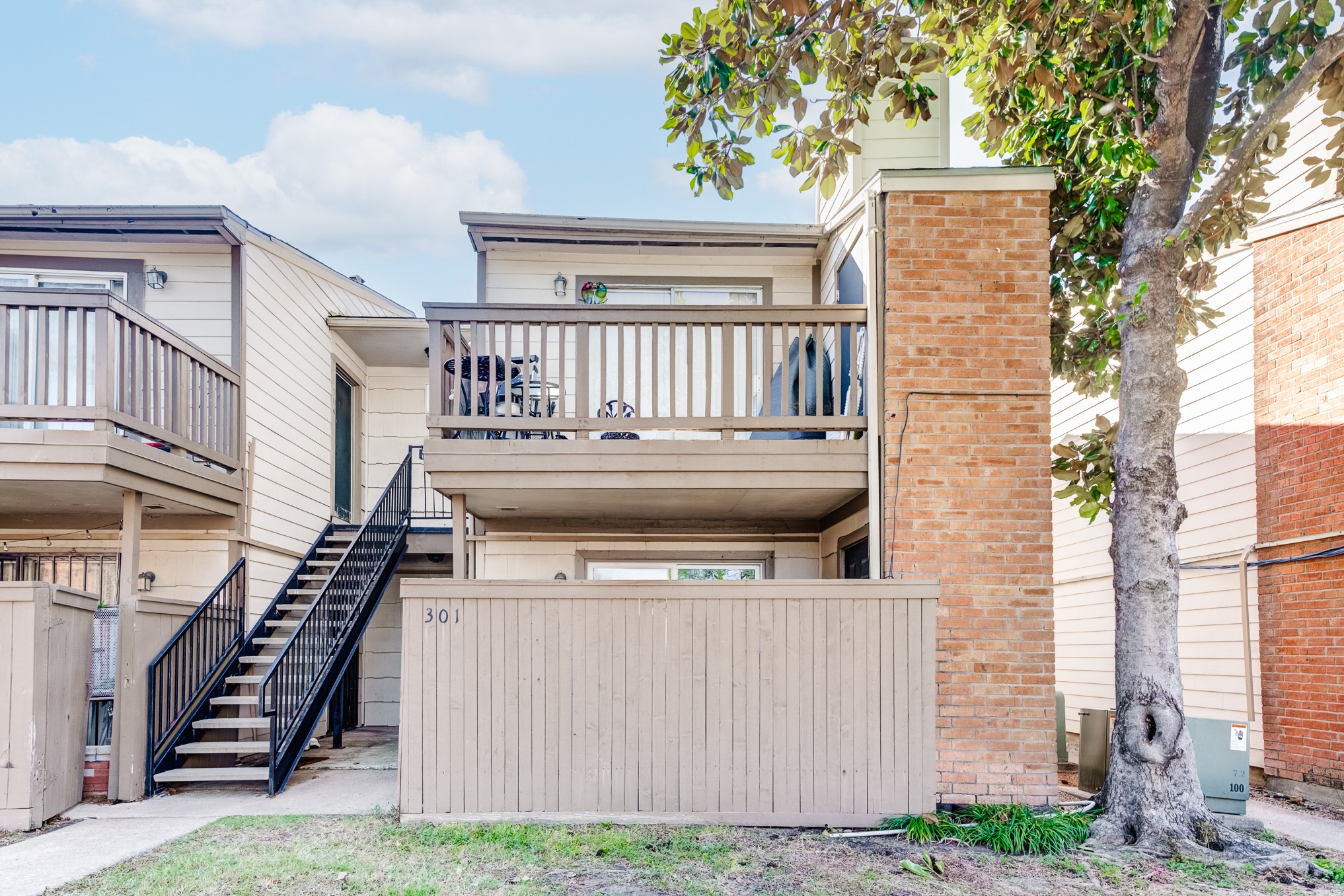 6001 Reims Road, Unit 301 Houston, TX 77036 - Photo 1 of 29 a view of a house with wooden fence