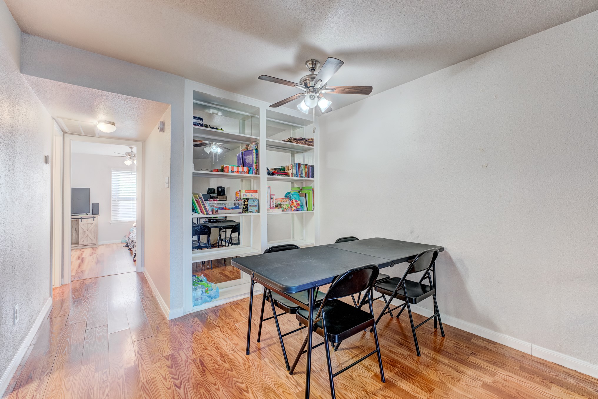 6001 Reims Road, Unit 301 Houston, TX 77036 - Photo 11 of 29 a view of a dining room with furniture and wooden floor