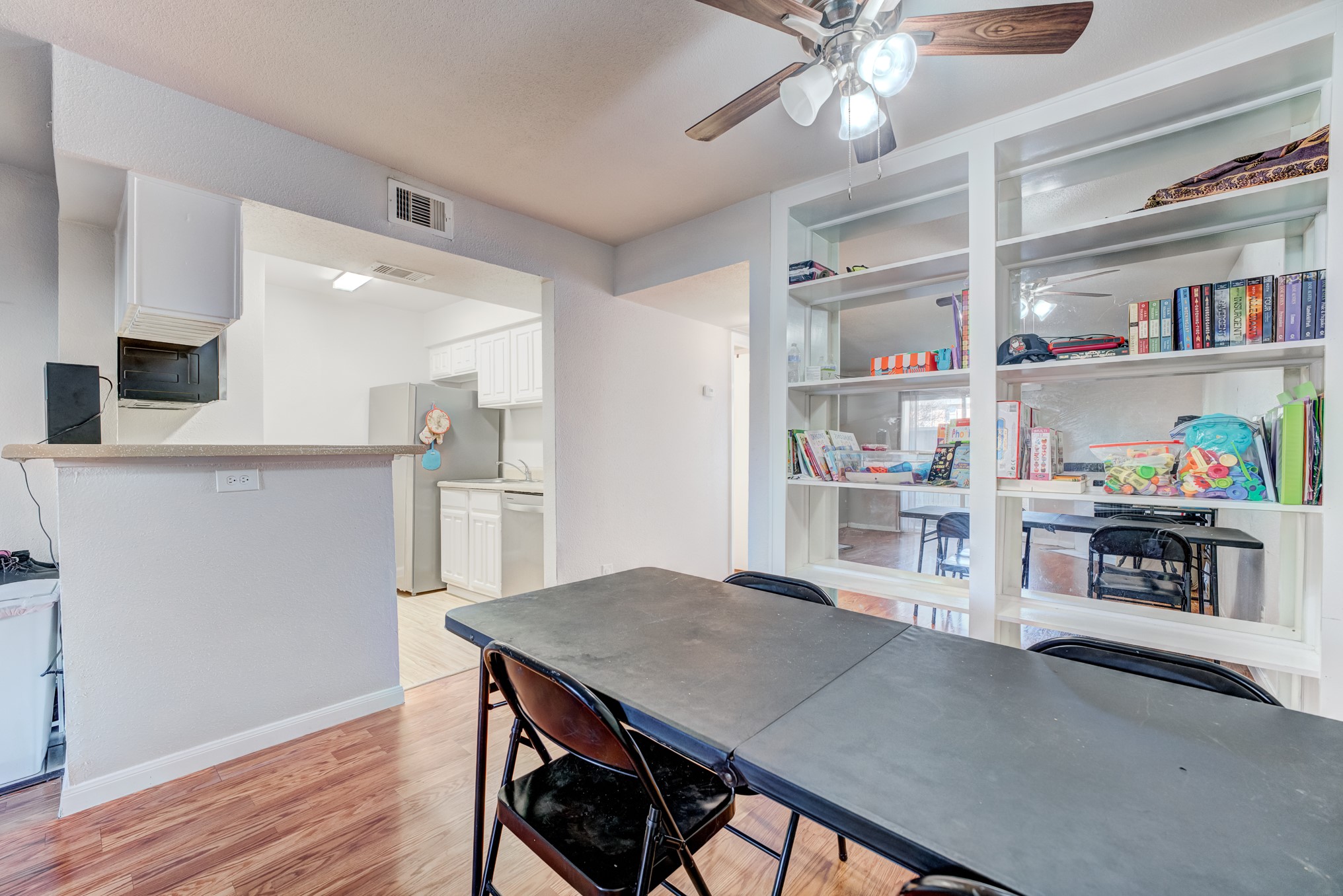 6001 Reims Road, Unit 301 Houston, TX 77036 - Photo 12 of 29 a view of kitchen and dining room with wooden floor
