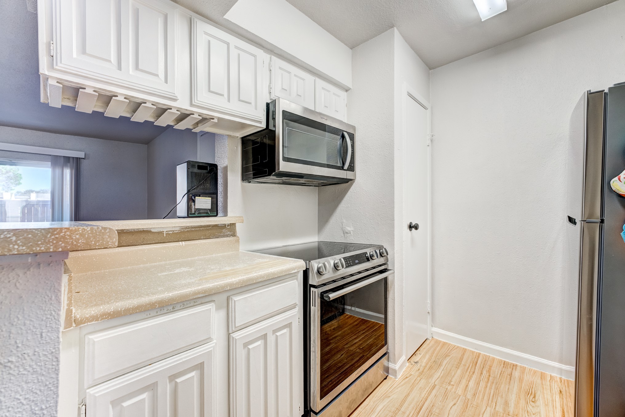 6001 Reims Road, Unit 301 Houston, TX 77036 - Photo 13 of 29 a kitchen with stainless steel appliances a microwave stove and cabinets