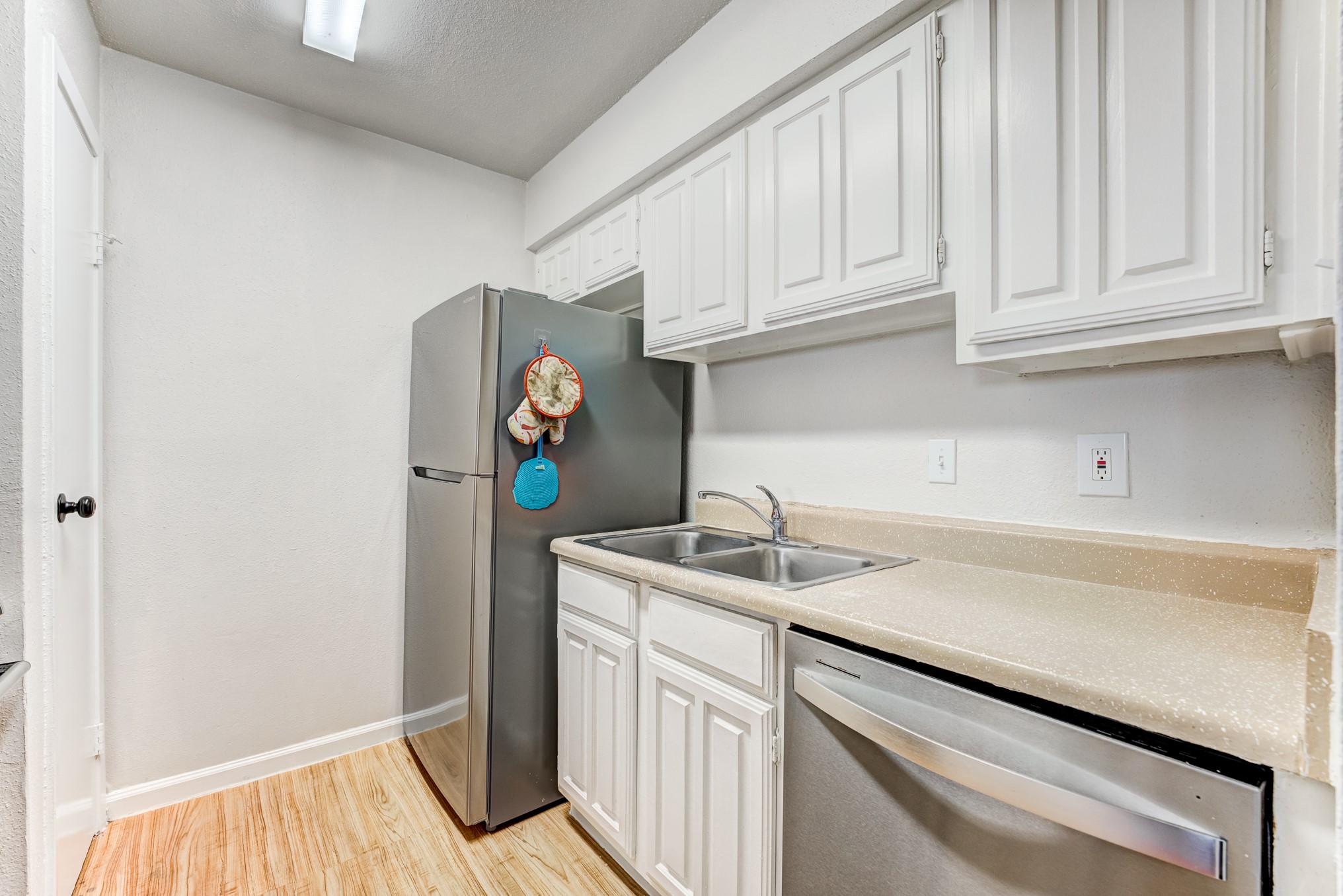 6001 Reims Road, Unit 301 Houston, TX 77036 - Photo 14 of 29 a kitchen with stainless steel appliances granite countertop a sink and dishwasher with white cabinets