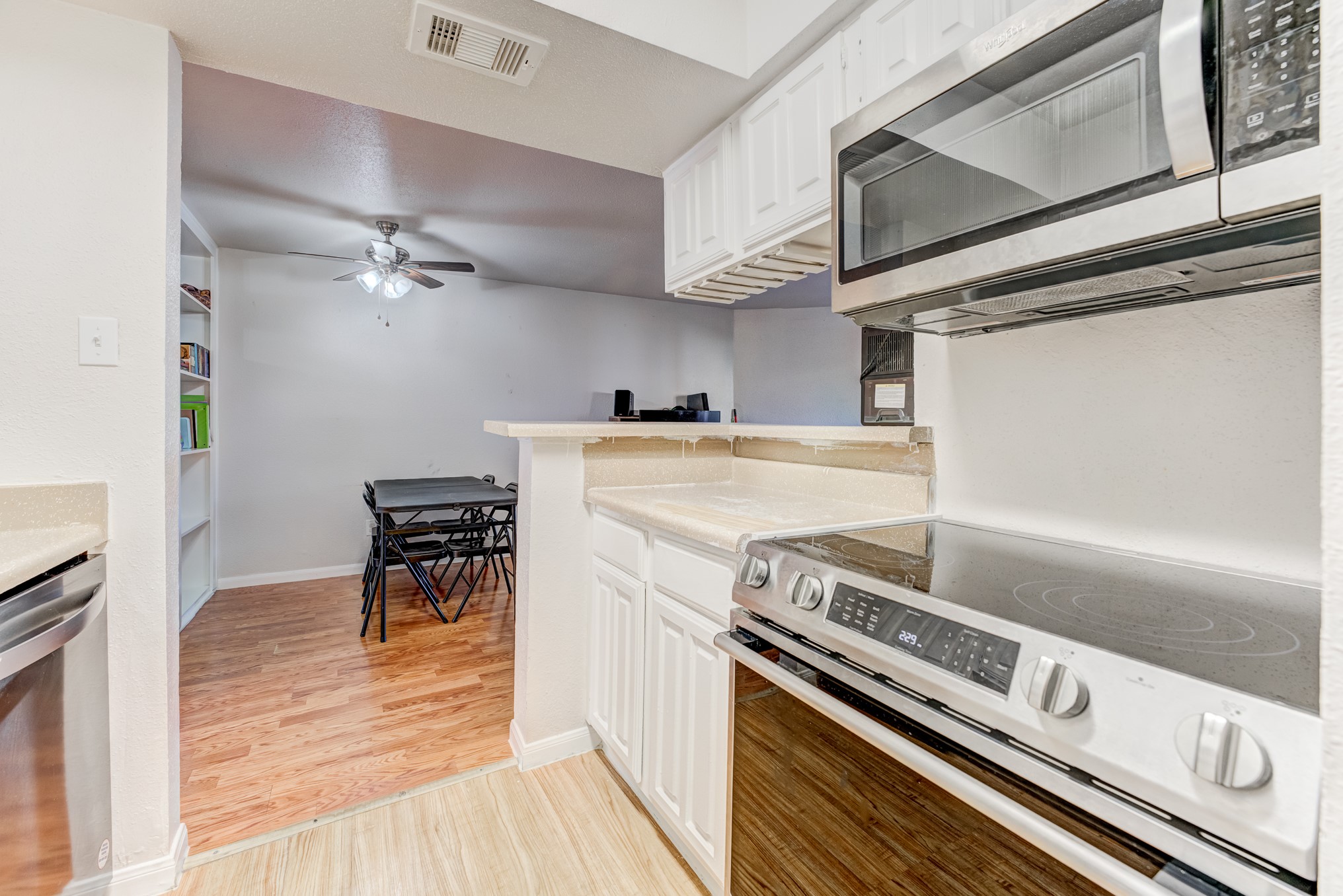 6001 Reims Road, Unit 301 Houston, TX 77036 - Photo 16 of 29 a kitchen with a stove and a microwave