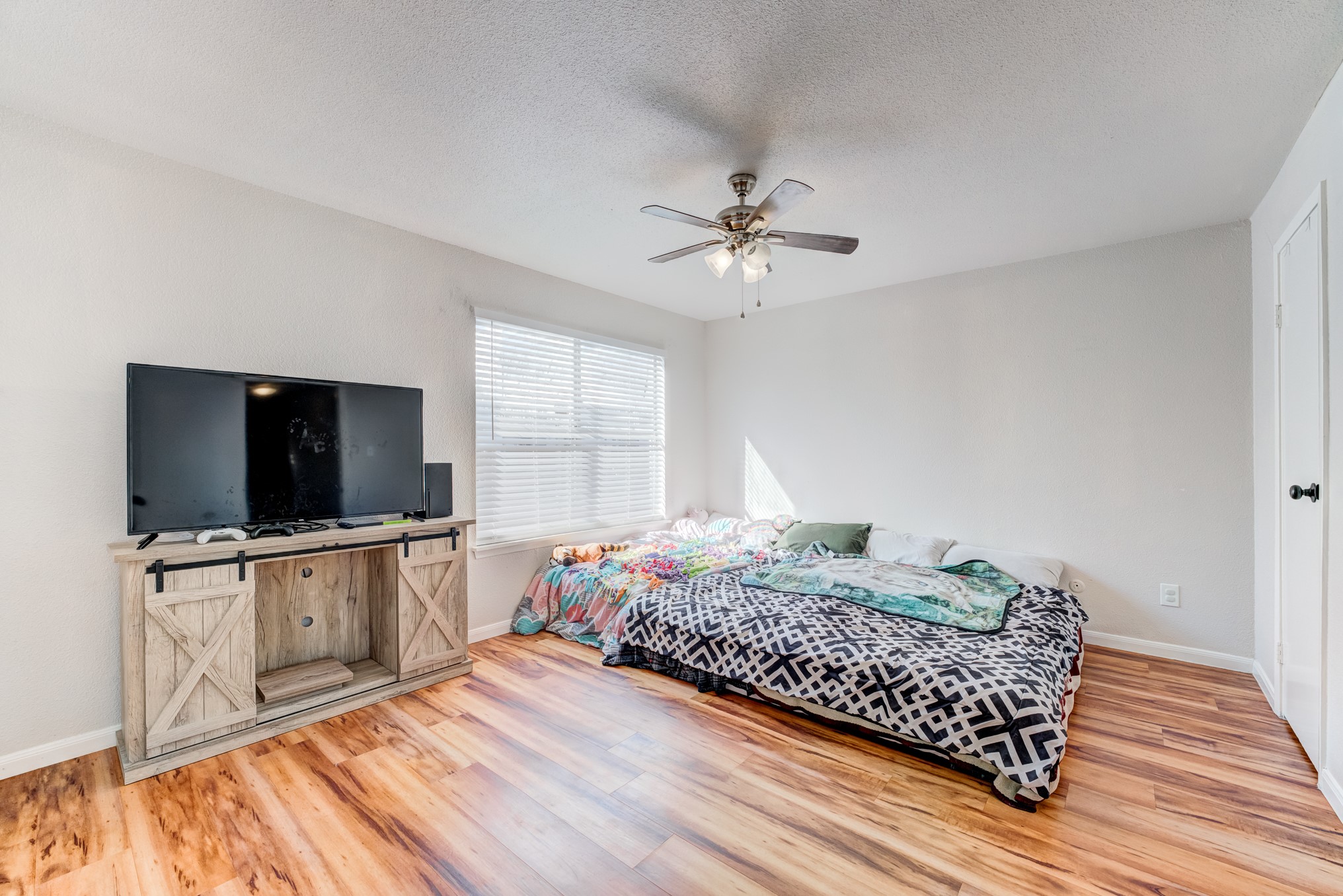 6001 Reims Road, Unit 301 Houston, TX 77036 - Photo 19 of 29 a bedroom with a bed and a flat screen tv