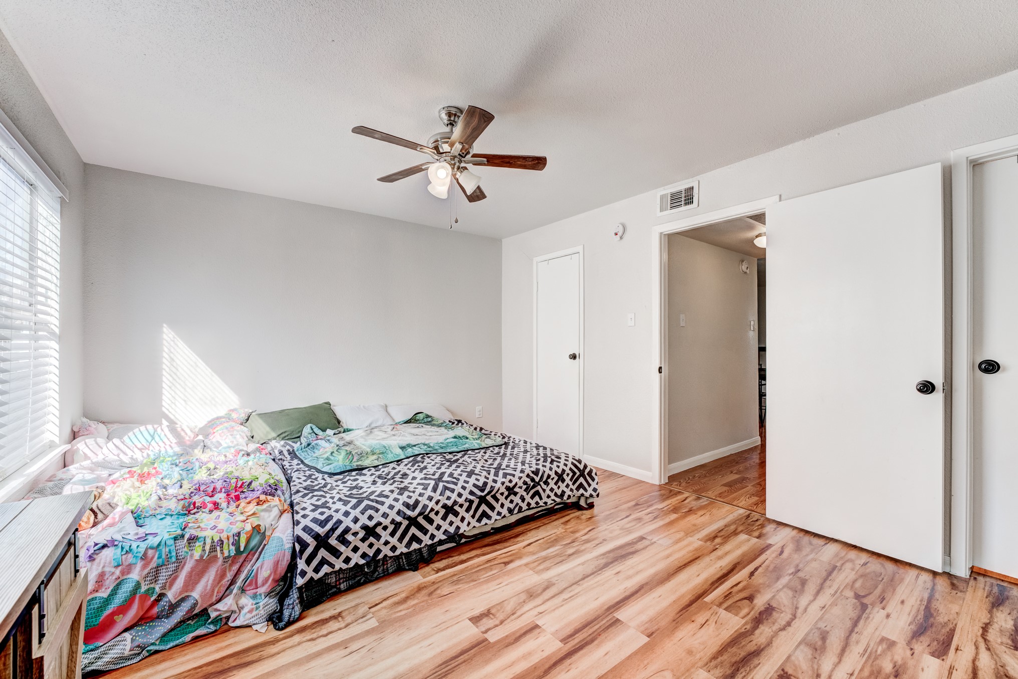 6001 Reims Road, Unit 301 Houston, TX 77036 - Photo 20 of 29 a bedroom with a bed and wooden floor