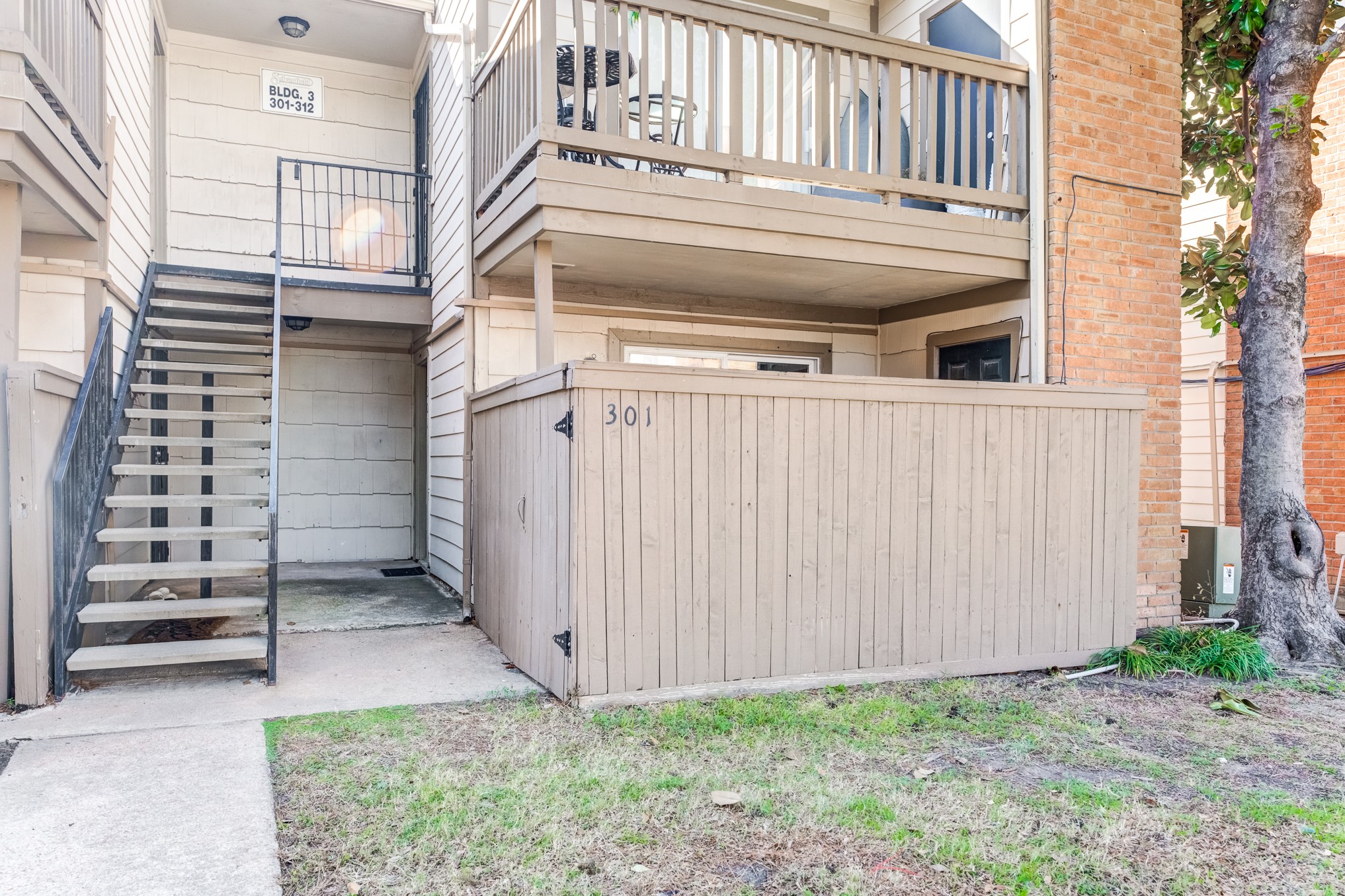 6001 Reims Road, Unit 301 Houston, TX 77036 - Photo 3 of 29 a view of a pathway of a house with white walls and a window