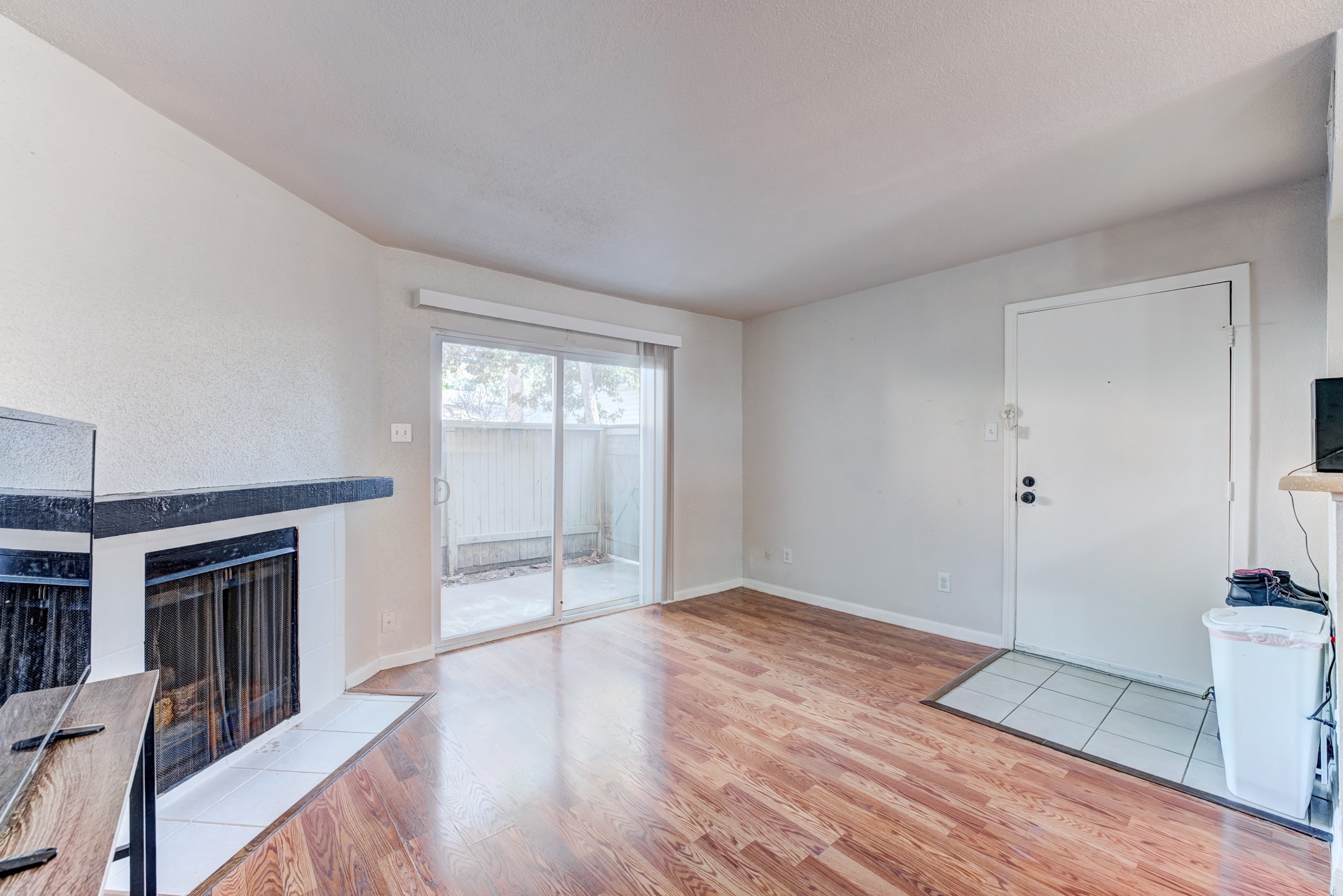6001 Reims Road, Unit 301 Houston, TX 77036 - Photo 8 of 29 a view of an empty room with window and wooden floor