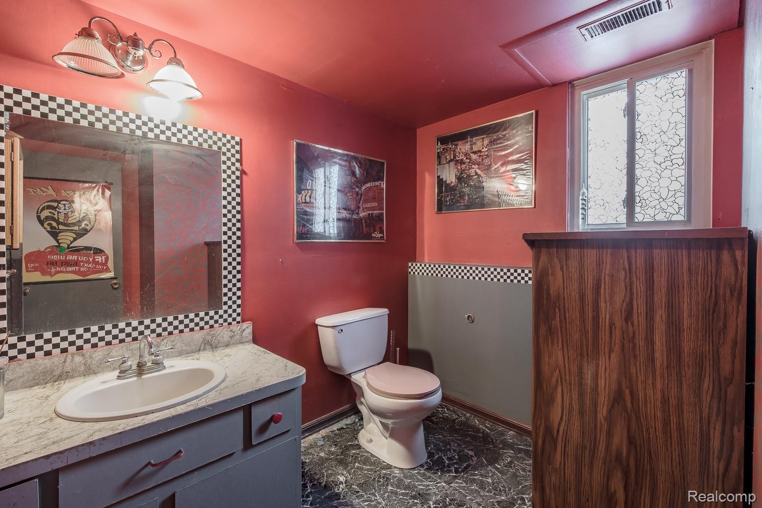 8670 North Eston Road Clarkston, MI 48348 - Photo 20 of 29 Half bath with vanity and backsplash