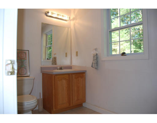 13 Fisher Road Chelmsford, MA 01824 - Photo 14 of 20 a bathroom with a sink a toilet and a mirror