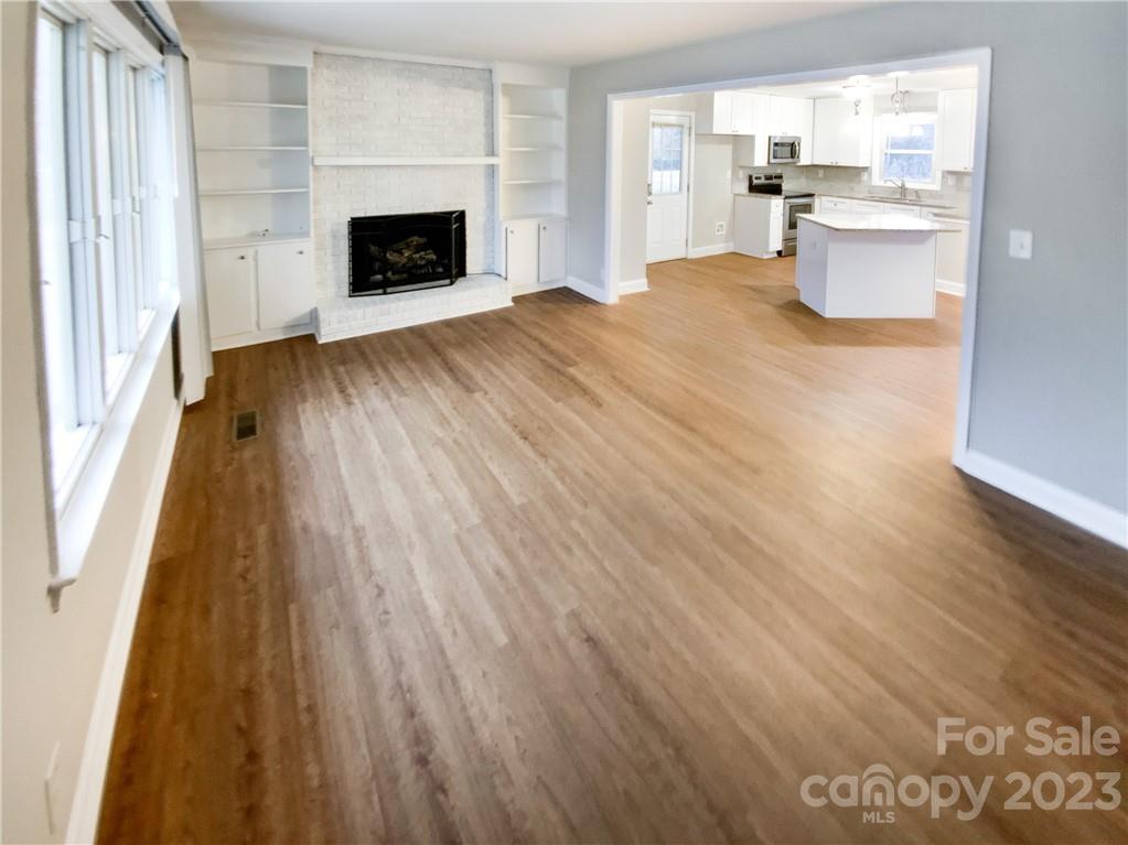 3020 Potter Road Waxhaw, NC 28173 - Photo 6 of 17 a view of a kitchen with wooden floor and a fireplace