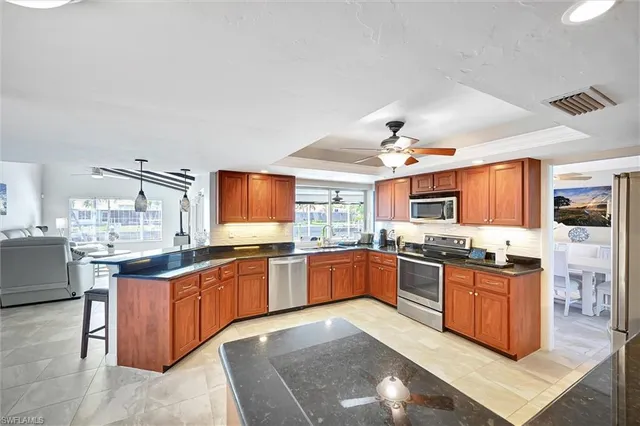 a kitchen with stainless steel appliances granite countertop stove top oven and sink