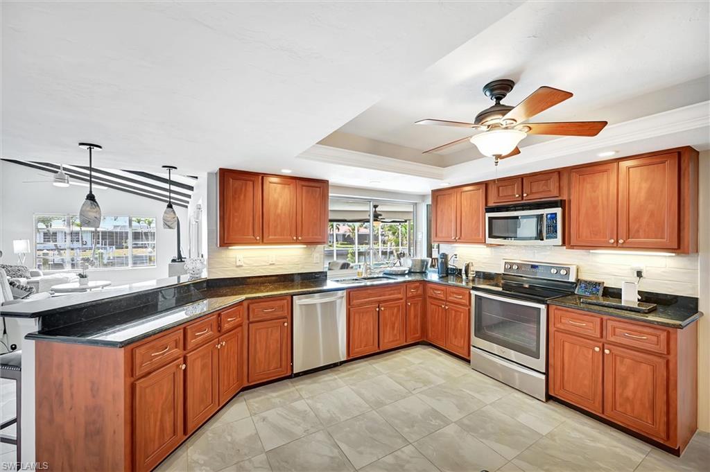 69 Ocean Drive Punta Gorda, FL 33950 - Photo 12 of 44 a kitchen with lots of counter top space sink and refrigerator