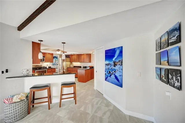 a living room with furniture and a kitchen view