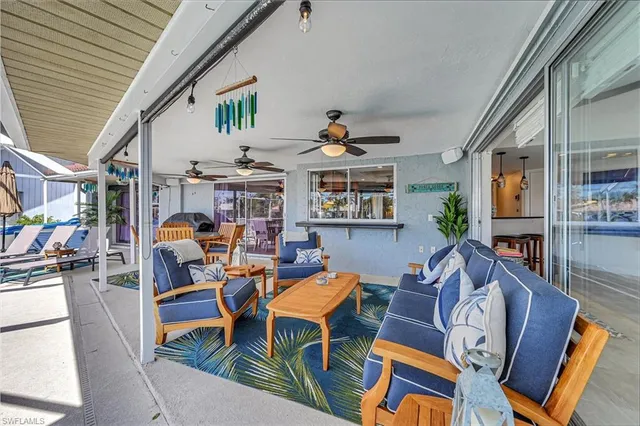 a living room with furniture a fireplace and a large window