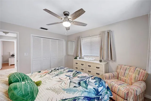a bedroom with a bed couch and window
