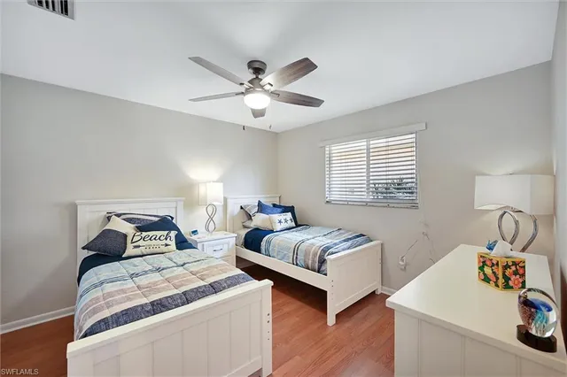 a bedroom with two beds and a window