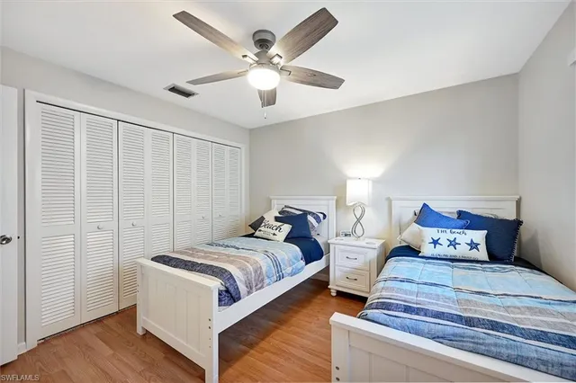 a bedroom with bed and a chandelier