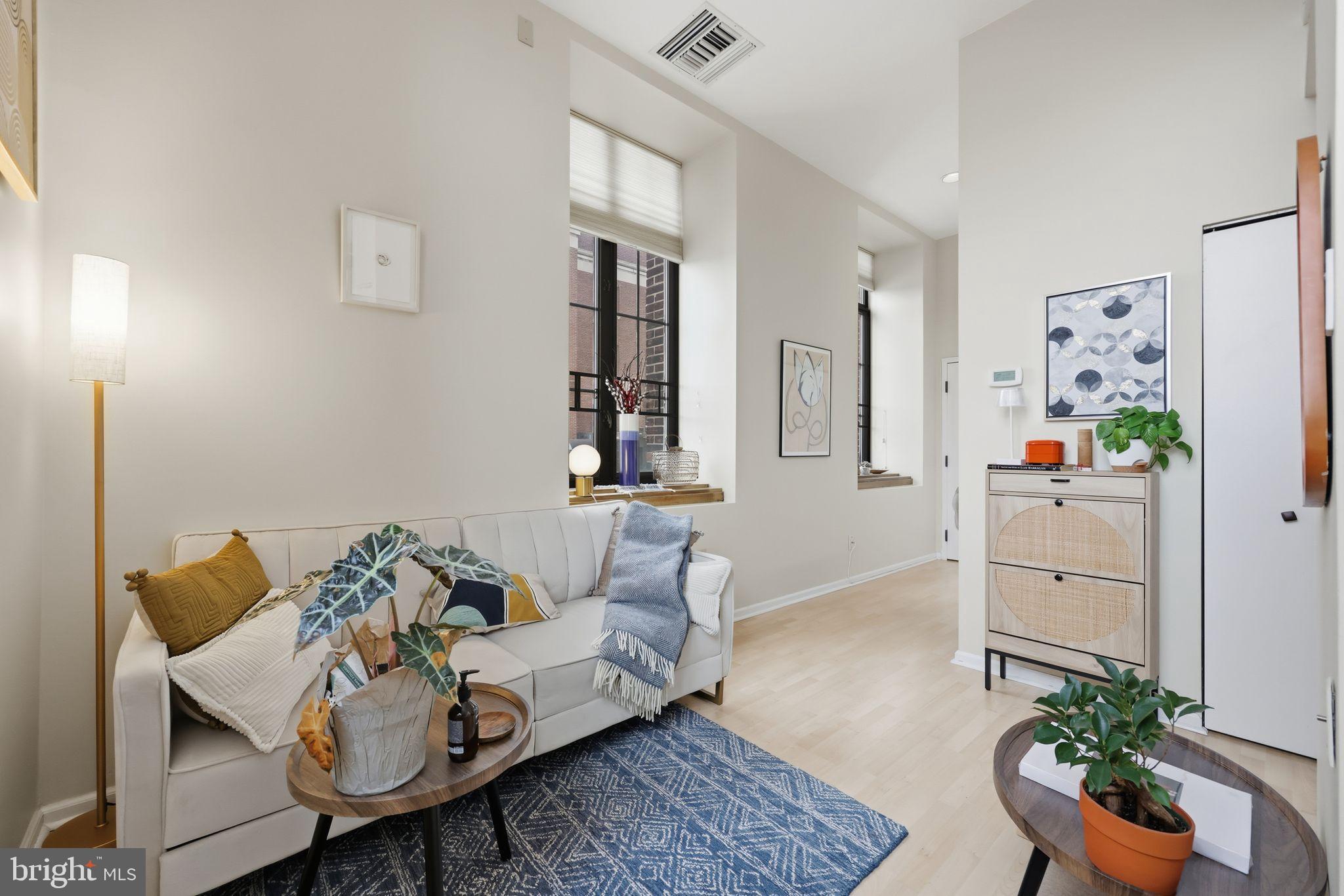 1601 Spring Garden Street, Unit 207 Philadelphia, PA 19130 - Photo 3 of 20 a living room with furniture and flowers