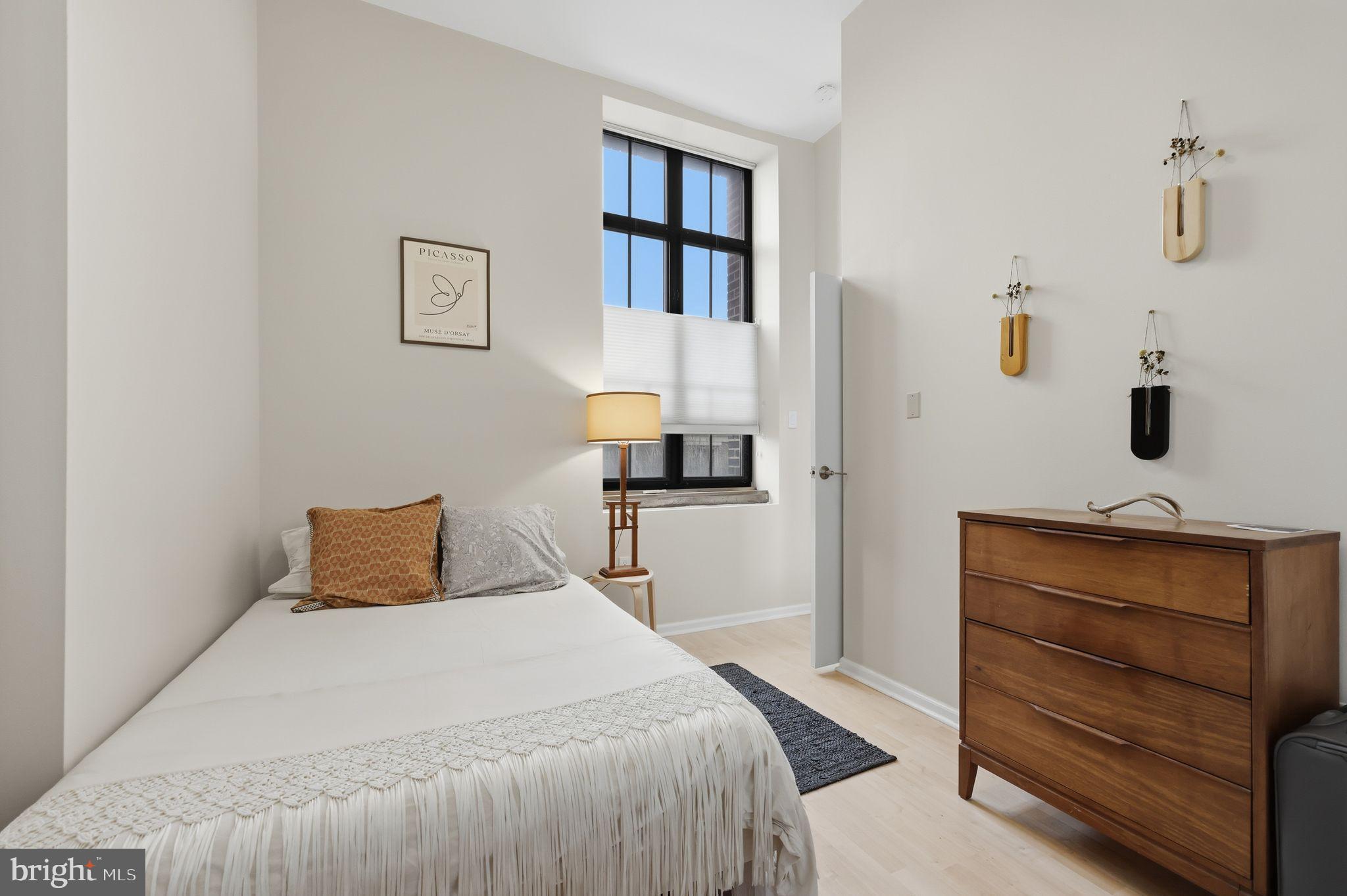 1601 Spring Garden Street, Unit 207 Philadelphia, PA 19130 - Photo 8 of 20 a bedroom with a bed and a lamp on dresser