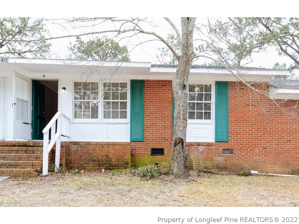 front view of a house with a tree