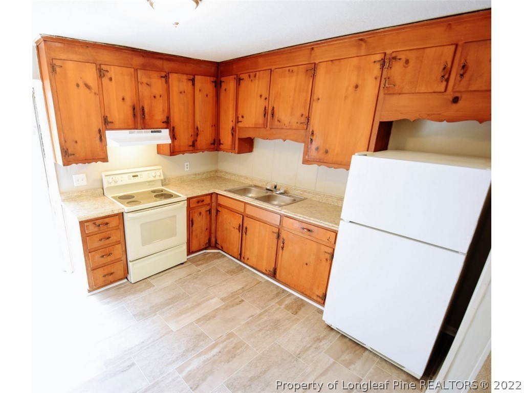 1308 King Street, Unit A Spring Lake, NC 28390 - Photo 4 of 11 a utility room with sink a washer and dryer