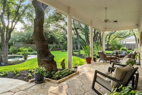 a view of a patio with chairs and a table