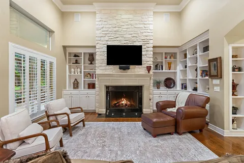 a living room with furniture a flat screen tv and a fireplace