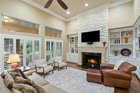 a living room with furniture a fireplace and a flat screen tv