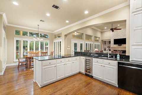 a kitchen with granite countertop a sink and cabinets