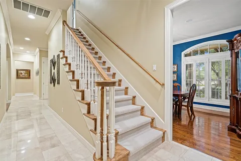a view of staircase with lots of frames and couches