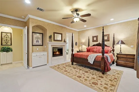 a bedroom with a large bed and a chandelier
