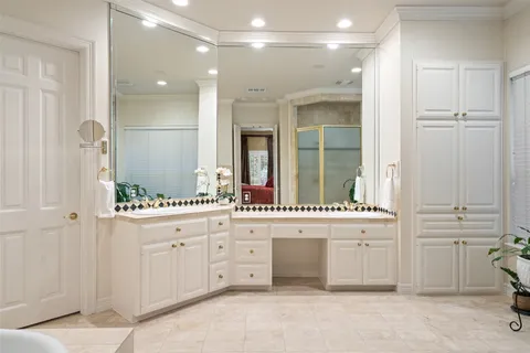 a bathroom with a double vanity sink a mirror and a bathtub