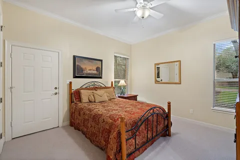 a bedroom with a large bed and a chandelier