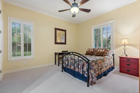 a bed sitting in a bedroom next to a window